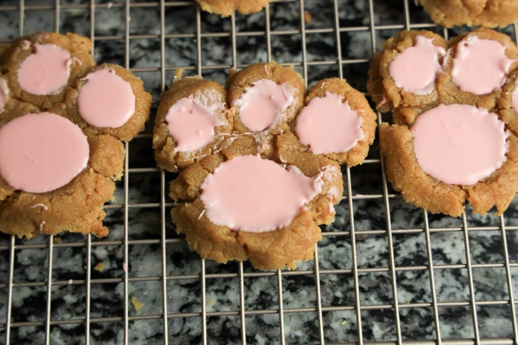 Peanut butter bunny paw cookies on a cookie cooling rack.
