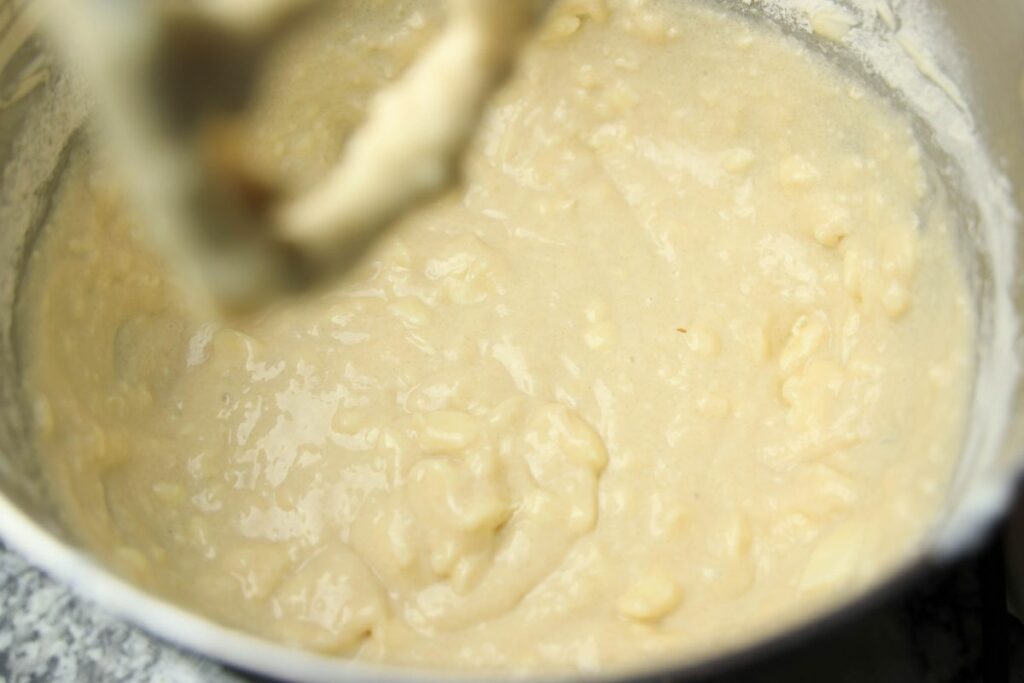 Wet ingredients in the bowl of a stand mixer.