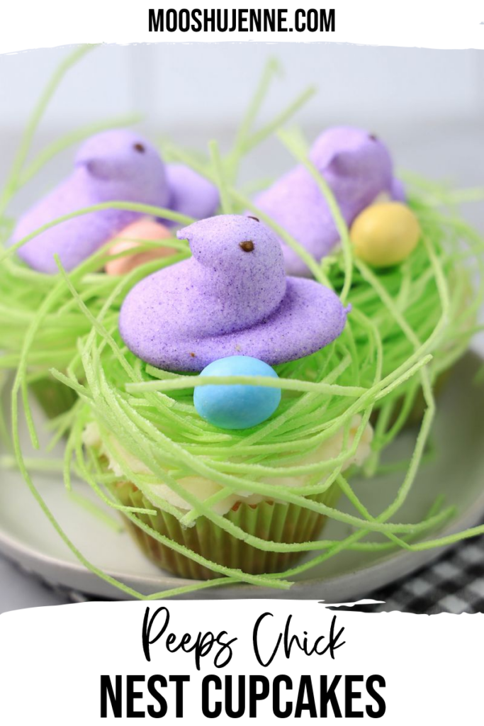 Peeps Chick nest cupcakes use the marshmallow candy to create an adorable nest cupcake adorned with a purple peeps chick, edible grass, and Hershey’s milk chocolate candy eggs.