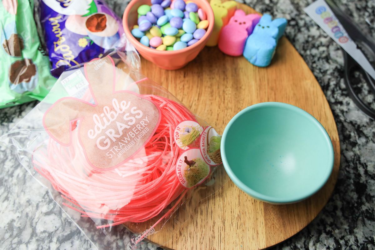 Light blue and pink bowls on a egg shaped wood board.