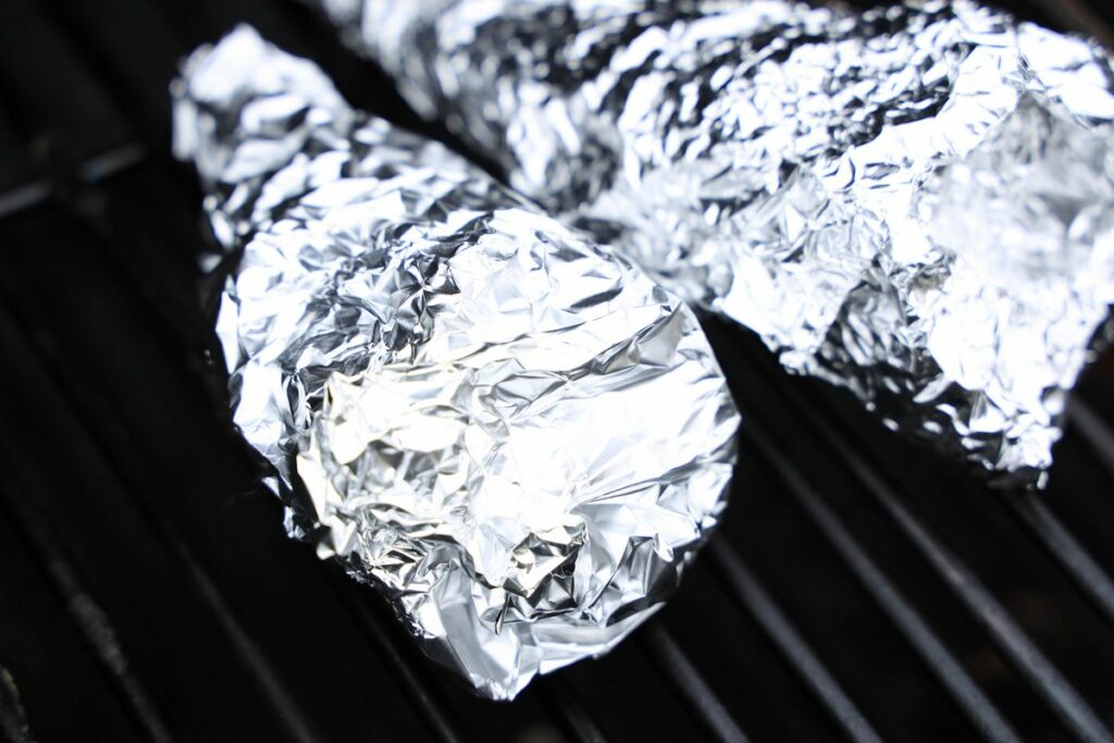 Shark campfire cones wrapped in foil on the grill.