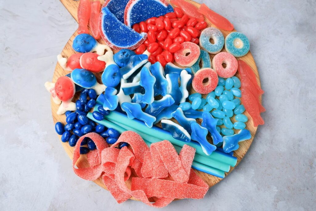 Shark Candy Charcuterie Board with red, light blue, and dark blue candy.