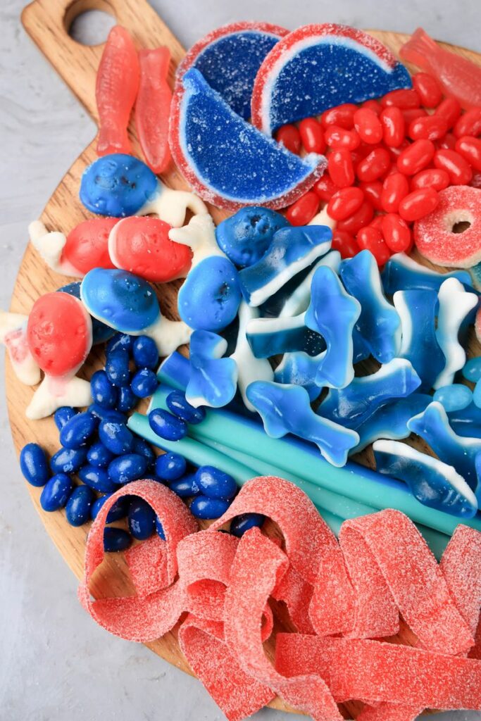 Shark Candy Charcuterie Board with red, light blue, and dark blue candy.