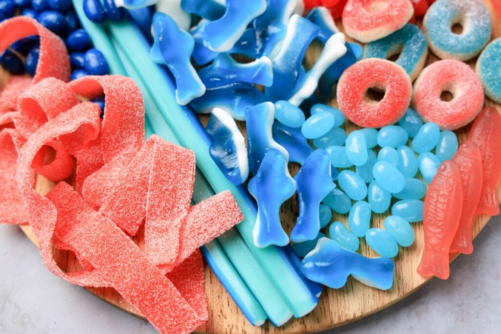 Shark Candy Charcuterie Board with red, light blue, and dark blue candy.