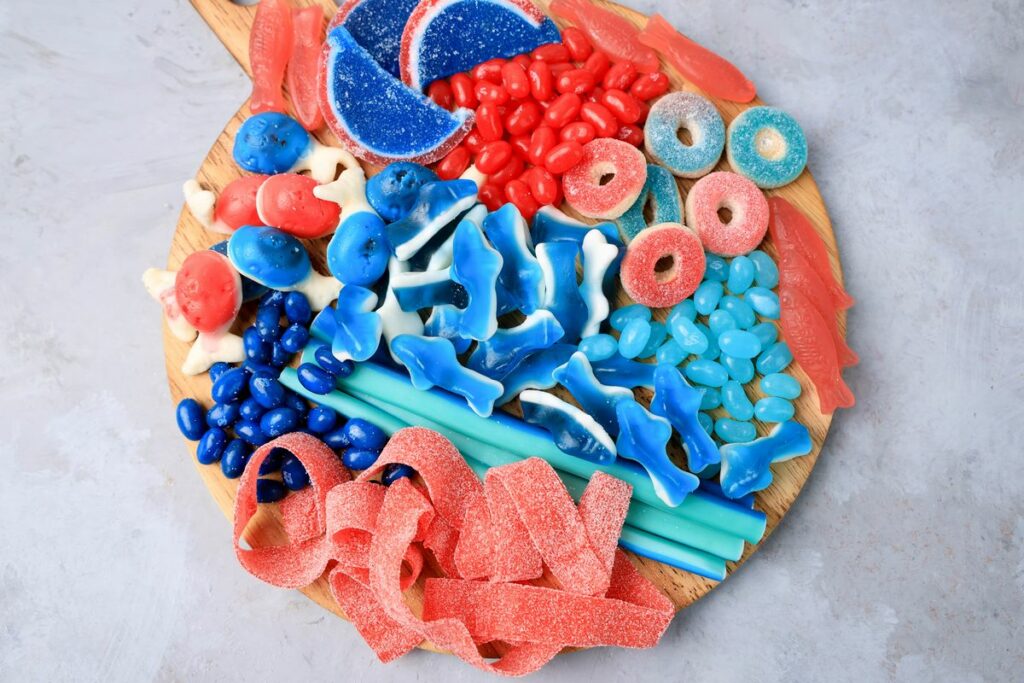 Shark Candy Charcuterie Board with red, light blue, and dark blue candy.