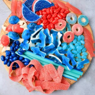 Shark Candy Charcuterie Board with red, light blue, and dark blue candy.