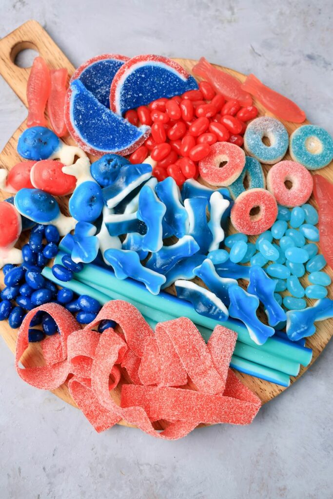 Shark Candy Charcuterie Board with red, light blue, and dark blue candy.