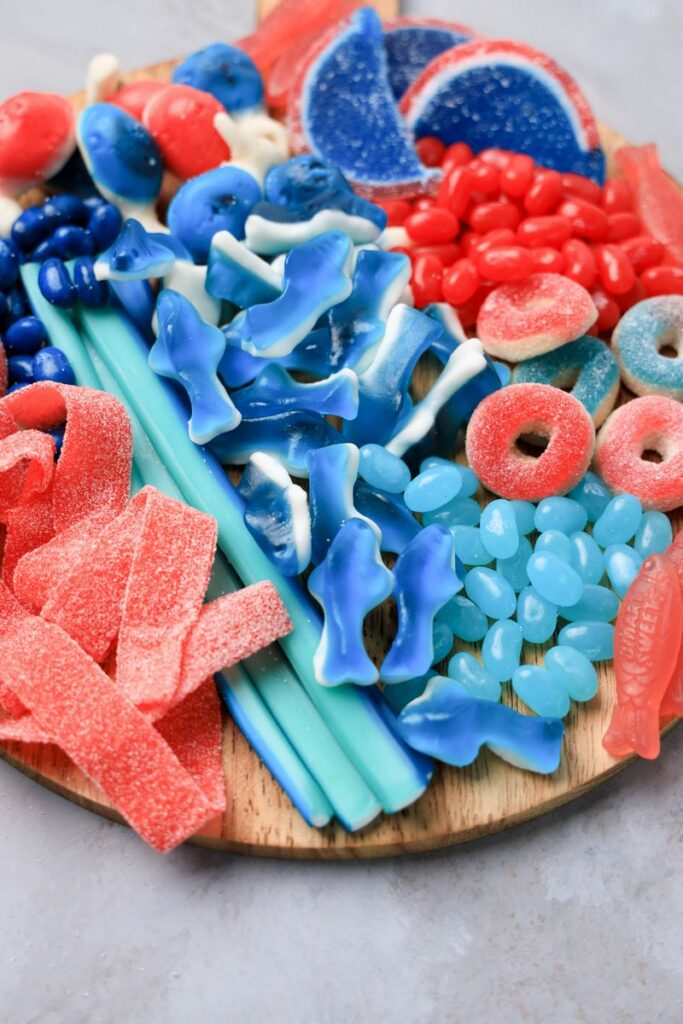 Shark Candy Charcuterie Board with red, light blue, and dark blue candy.
