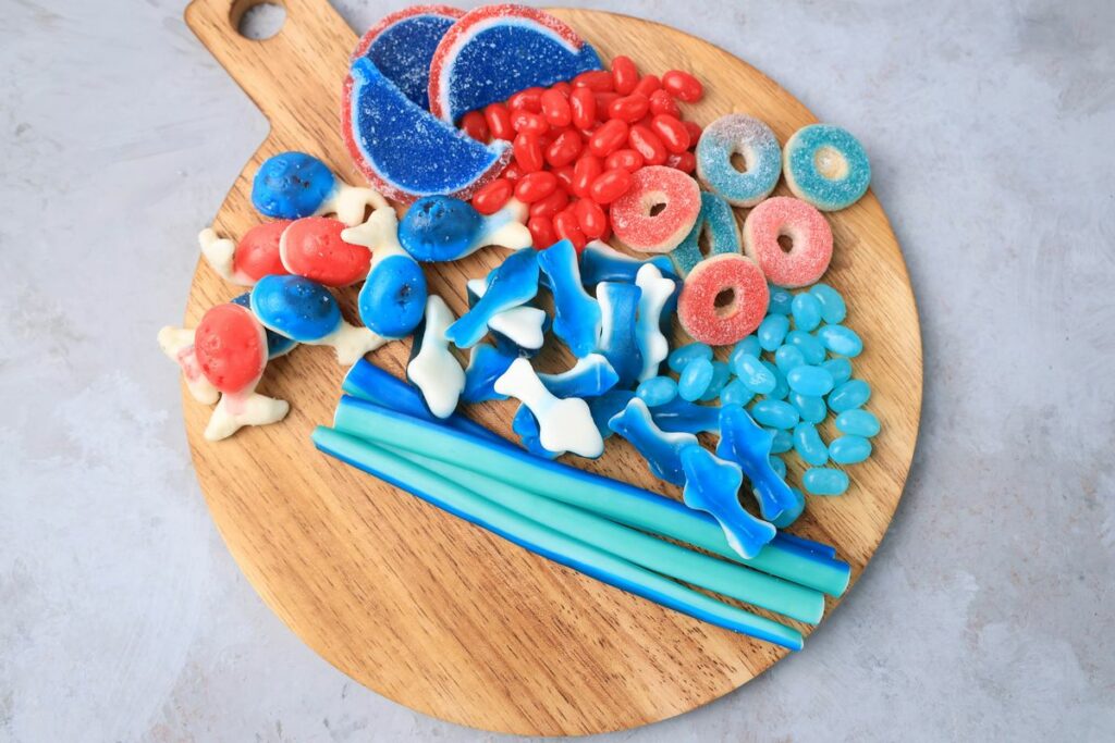 Shark Candy Charcuterie Board with red, light blue, and dark blue candy.