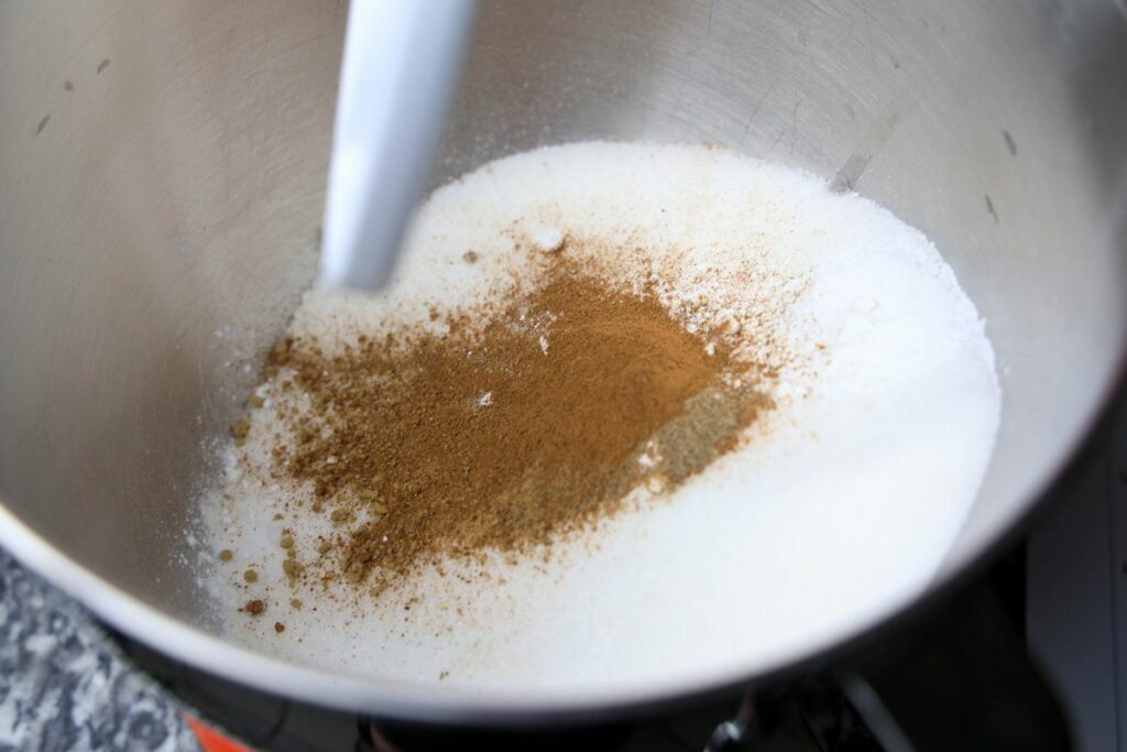 Spices and flour in a stainless mixing bowl.