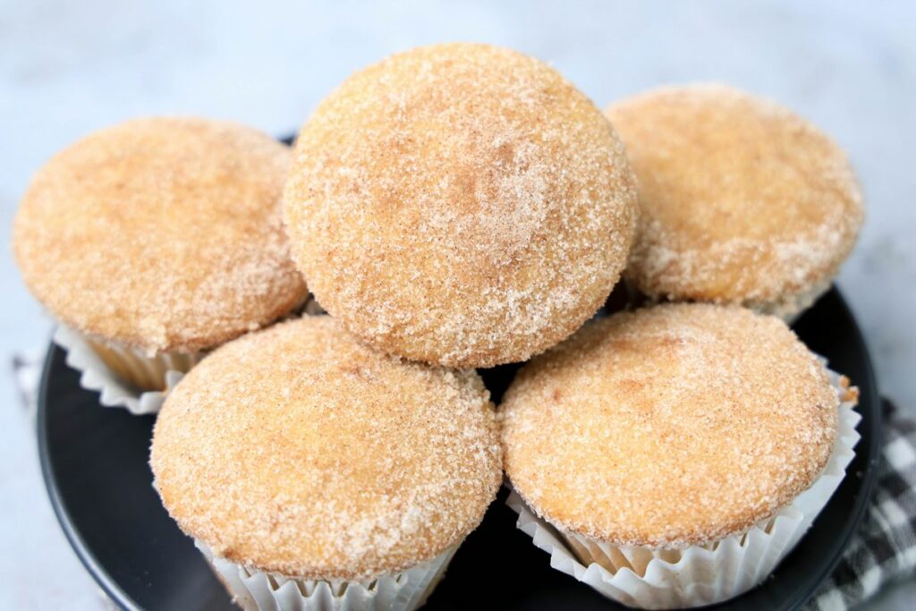 Apple Cider Muffins on a gray plate with a gray and white plaid napkin.