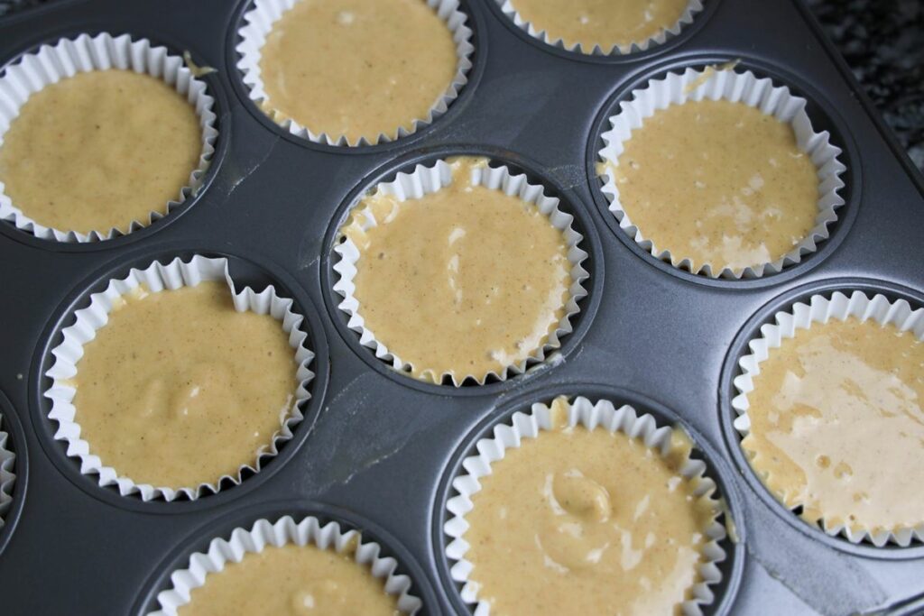 Apple cider muffin mix in the white cupcake liners.