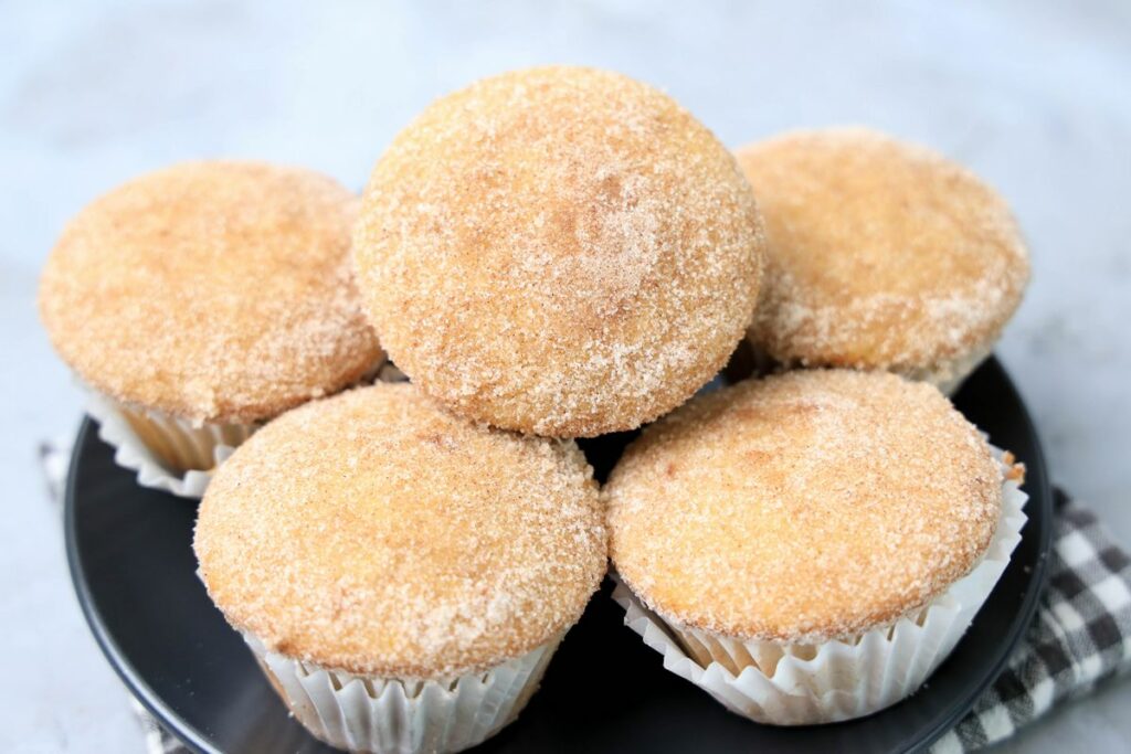 Apple Cider Muffins on a gray plate with a gray and white plaid napkin.