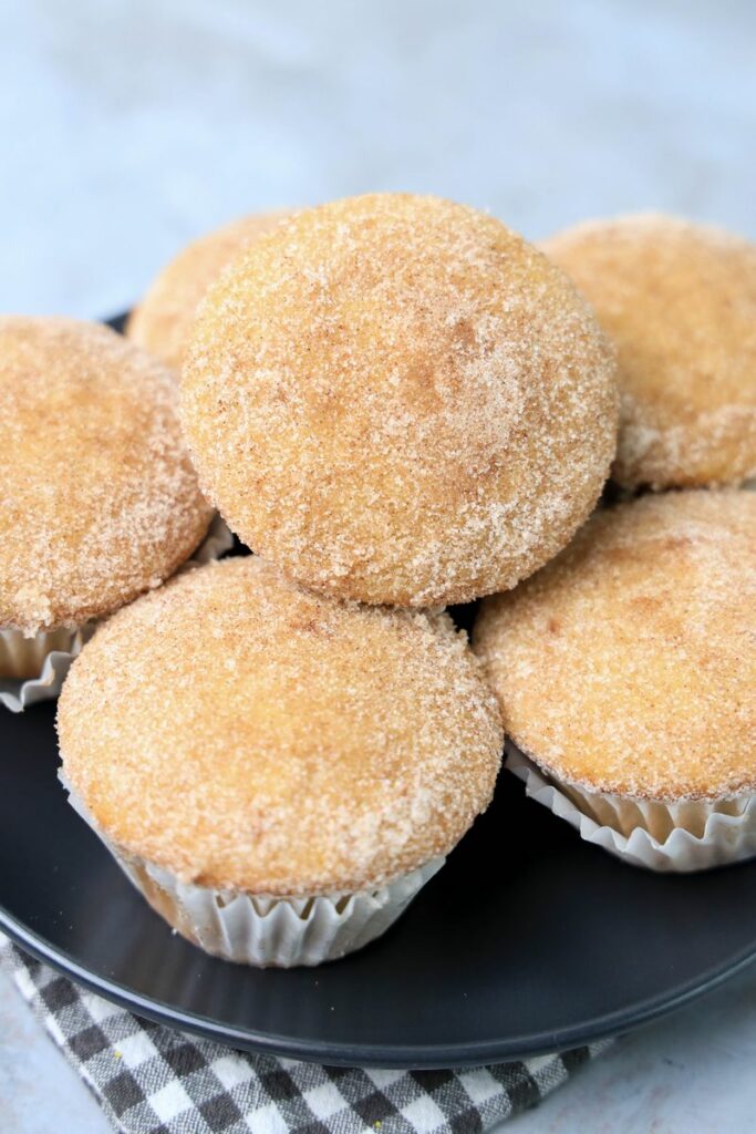 Apple Cider Muffins on a gray plate with a gray and white plaid napkin.