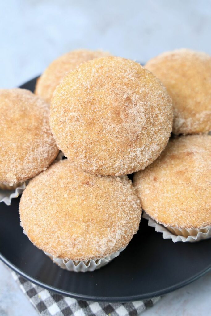 Apple Cider Muffins on a gray plate with a gray and white plaid napkin.