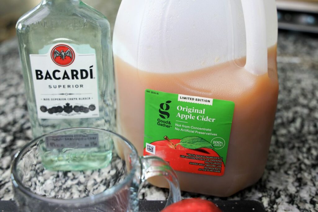 Apple cider and rum on a counter top.