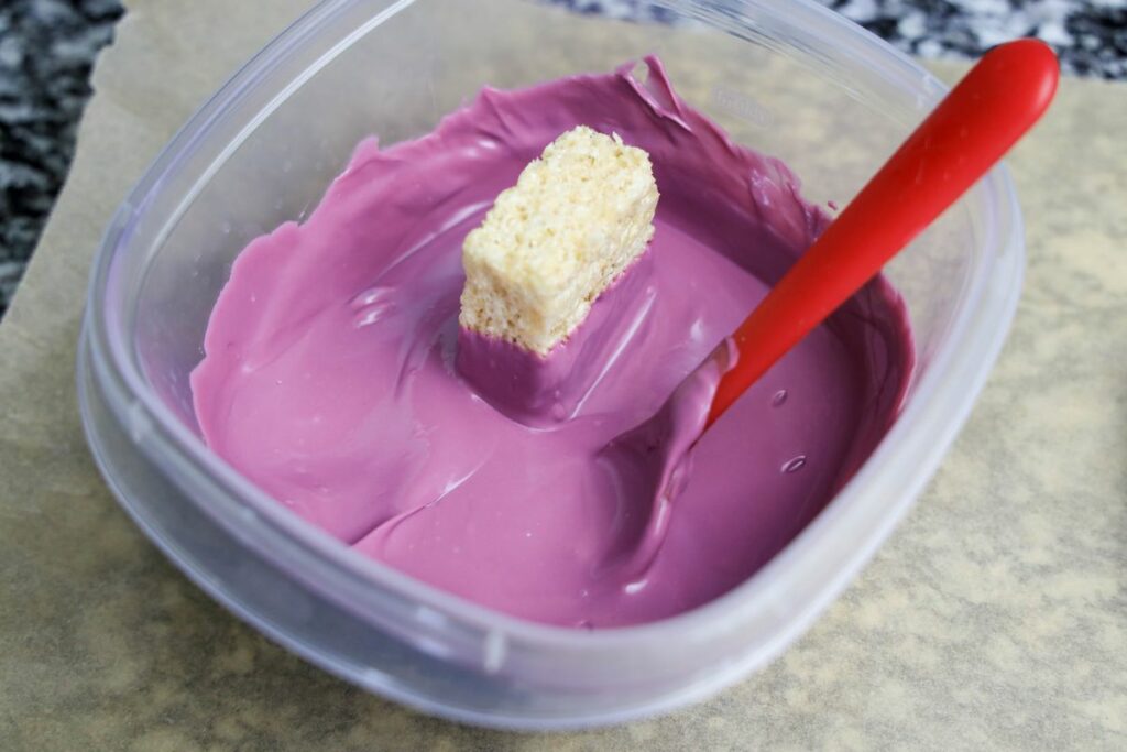 Rice krispie treat dipped in purple candy melts.
