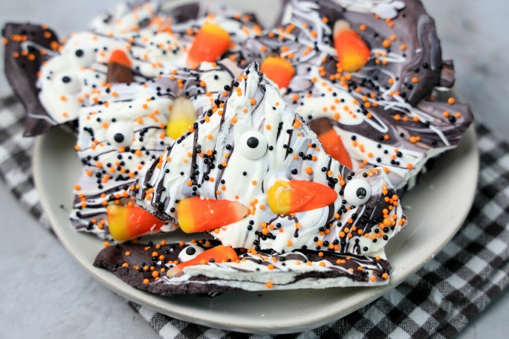 Vintage Halloween bark on a white plate with a gray plaid napkin.