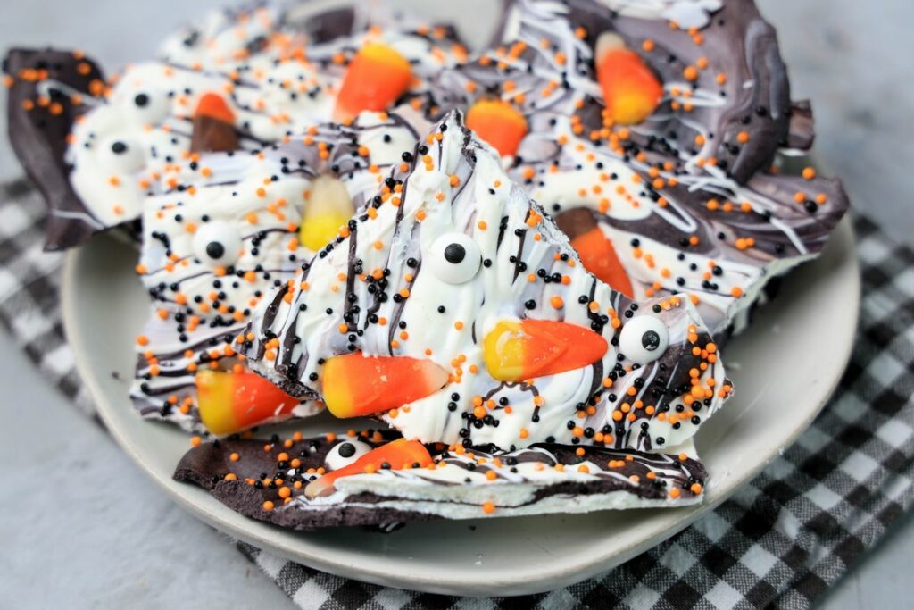 Vintage Halloween bark on a white plate with a gray plaid napkin.