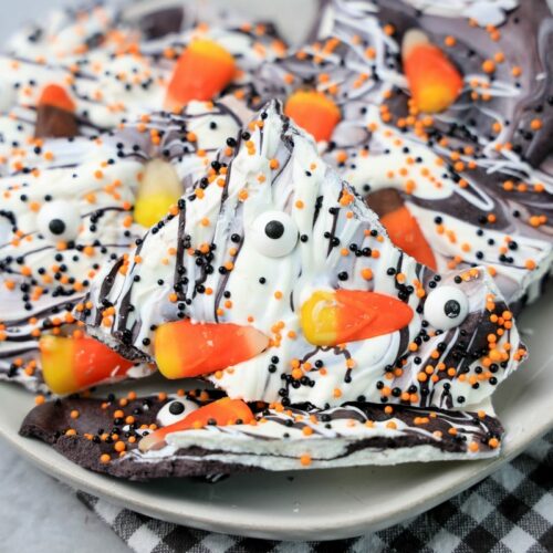 Vintage Halloween bark on a white plate with a gray plaid napkin.