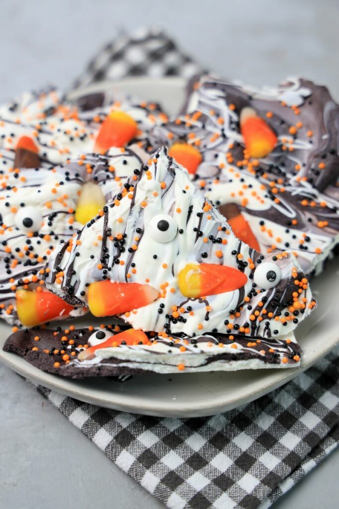 Vintage Halloween bark on a white plate with a gray plaid napkin.