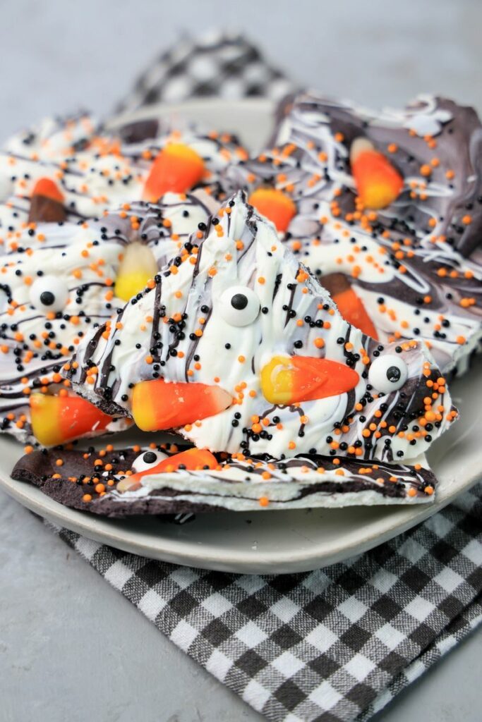 Vintage Halloween bark on a white plate with a gray plaid napkin.